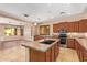 Bright kitchen featuring a central island with sink and pendant lighting at 29703 N 70Th Ave, Peoria, AZ 85383