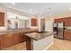 Updated kitchen island with sink, stainless steel appliances, and custom cabinetry at 29703 N 70Th Ave, Peoria, AZ 85383