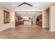 Expansive living space featuring wood-look floors and an open layout leading to a modern kitchen and dining area at 29703 N 70Th Ave, Peoria, AZ 85383
