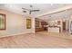 Open-concept living area showcasing wood-look tile, a ceiling fan, and a seamless flow to the kitchen at 29703 N 70Th Ave, Peoria, AZ 85383
