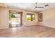 Spacious living room with wood-look tile floors, access to the backyard, and ample natural light at 29703 N 70Th Ave, Peoria, AZ 85383