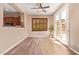 Well-lit living room with wood-look tile flooring, plantation shutters, and access to the backyard at 29703 N 70Th Ave, Peoria, AZ 85383