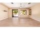 Open living area with wood-look tile, ceiling fan, and sliding glass doors to the backyard at 29703 N 70Th Ave, Peoria, AZ 85383