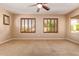 Spacious main bedroom with ceiling fan and windows offering great natural light and neutral colors at 29703 N 70Th Ave, Peoria, AZ 85383