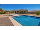 A beautiful pool with lounge chair in a desert landscaped backyard with a covered patio at 29703 N 70Th Ave, Peoria, AZ 85383