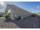 Spacious backyard with pool, artificial grass, desert landscaping and a rock covered area at 3661 E Appaloosa Dr, San Tan Valley, AZ 85140