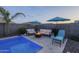 Inviting backyard featuring a swimming pool, fire pit, lounge seating, and lush landscaping at 3661 E Appaloosa Dr, San Tan Valley, AZ 85140