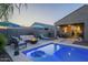 Gorgeous backyard featuring a pool, comfortable seating, and fire pit, ideal for entertaining and relaxing at 3661 E Appaloosa Dr, San Tan Valley, AZ 85140
