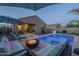 Beautiful backyard with a pool, fire pit, and lounge seating, perfect for relaxation and outdoor gatherings at 3661 E Appaloosa Dr, San Tan Valley, AZ 85140