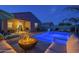 Tranquil backyard featuring a sparkling pool, fire pit, and comfortable lounge seating at 3661 E Appaloosa Dr, San Tan Valley, AZ 85140