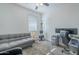 Bedroom features a futon, desk setup, and rowing machine for exercise, all on soft carpeting at 3661 E Appaloosa Dr, San Tan Valley, AZ 85140