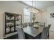 Dining room features a modern chandelier, a display cabinet, and seating for six at 3661 E Appaloosa Dr, San Tan Valley, AZ 85140