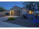 Charming single-Gathering home with a two-car garage and well-maintained front yard landscaping at dusk at 3661 E Appaloosa Dr, San Tan Valley, AZ 85140