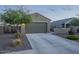 Exterior of a one-story home with a two-car garage, desert landscaping, and an extended driveway at 3661 E Appaloosa Dr, San Tan Valley, AZ 85140