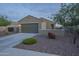 Exterior view of a one-story home with a two-car garage, desert landscaping, and block wall at 3661 E Appaloosa Dr, San Tan Valley, AZ 85140