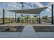 Community playground featuring modern play structures and covered shade structures with a sidewalk at 3661 E Appaloosa Dr, San Tan Valley, AZ 85140