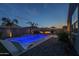 Inviting backyard pool area with lounge chair, outdoor seating, fire pit, and lush landscaping perfect for entertaining at 3661 E Appaloosa Dr, San Tan Valley, AZ 85140