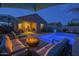 Inviting backyard pool area features a fire pit, lounge seating, and covered patio, perfect for relaxing and entertaining at 3661 E Appaloosa Dr, San Tan Valley, AZ 85140