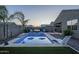 Backyard pool with comfortable outdoor seating, landscaping, and a privacy wall at 3661 E Appaloosa Dr, San Tan Valley, AZ 85140