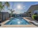 Backyard pool and patio area featuring lounge chairs, umbrellas, and lush landscaping at 3661 E Appaloosa Dr, San Tan Valley, AZ 85140