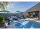 This backyard features a beautiful pool and outdoor living space, ideal for enjoying the Arizona sunshine at 3661 E Appaloosa Dr, San Tan Valley, AZ 85140