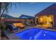 Backyard pool features seating, fire pit, and covered patio, creating an inviting outdoor living space at 3661 E Appaloosa Dr, San Tan Valley, AZ 85140