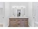 Bright bathroom with double sinks, wood cabinets, and modern lighting fixtures at 4220 N 32Nd St # 7, Phoenix, AZ 85018