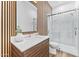 Contemporary bathroom with stylish wood-grain accent wall, glass shower, and modern vanity at 4220 N 32Nd St # 7, Phoenix, AZ 85018