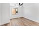 Minimalist bedroom with wood flooring, bright window, and modern ceiling fan at 4220 N 32Nd St # 7, Phoenix, AZ 85018