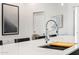 Kitchen island featuring a modern faucet, integrated sink, and bright interiors at 4220 N 32Nd St # 7, Phoenix, AZ 85018