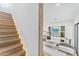 Open concept living space with illuminated stairs, white sofa and lots of natural light at 4220 N 32Nd St # 7, Phoenix, AZ 85018