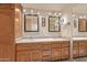 Bathroom featuring double sinks, and large mirrors with vanity lighting at 4303 E Cactus Rd # 202, Phoenix, AZ 85032