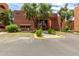 View of clubhouse, mature trees and landscape at 4303 E Cactus Rd # 202, Phoenix, AZ 85032