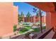 Scenic courtyard view with a pristine pool, lush greenery, and charming architecture of the resort at 4303 E Cactus Rd # 202, Phoenix, AZ 85032