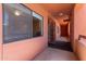 Condo hallway featuring an exit sign and peach colored paint and doors at 4303 E Cactus Rd # 202, Phoenix, AZ 85032