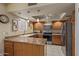 Kitchen featuring pendant lights, tile flooring, oak cabinets, and stainless steel appliances at 4303 E Cactus Rd # 202, Phoenix, AZ 85032