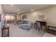 Living room featuring carpet, a desk, a ceiling fan, and access to outdoor patio at 4303 E Cactus Rd # 202, Phoenix, AZ 85032