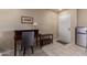 View of the living area featuring tile floors, a desk, and a mini refrigerator at 4303 E Cactus Rd # 202, Phoenix, AZ 85032