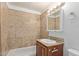 Updated bathroom with tiled shower, granite vanity, and ample lighting at 452 S Horne --, Mesa, AZ 85204