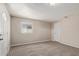 Spacious bedroom featuring neutral walls, plush carpet, a window, and two doors for easy access at 452 S Horne --, Mesa, AZ 85204