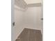 Walk-in closet with neutral walls, carpeted floor, shelving, and ample storage space at 452 S Horne --, Mesa, AZ 85204
