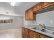 A kitchen view shows stainless steel double sinks, wood cabinets and view into the next room at 452 S Horne --, Mesa, AZ 85204