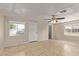 Bright living room with tile flooring, neutral walls, a ceiling fan, and a window for natural light at 452 S Horne --, Mesa, AZ 85204