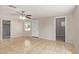 Bright living room featuring tile flooring, neutral walls, a ceiling fan, and a white front door at 452 S Horne --, Mesa, AZ 85204