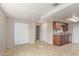 An open living room features neutral walls, tile flooring and access to the kitchen at 452 S Horne --, Mesa, AZ 85204