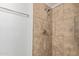 Bathroom shower featuring tiled walls, a modern shower head, and chrome fixtures at 452 S Horne --, Mesa, AZ 85204