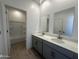 Well-lit bathroom with double sinks, quartz countertops, and modern fixtures at 47219 W Pecan Woods --, Maricopa, AZ 85139