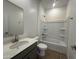 Bathroom features a vanity with quartz countertops, tub and shower at 47219 W Pecan Woods --, Maricopa, AZ 85139