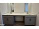 Bathroom featuring a double vanity with grey cabinets and quartz countertops at 47219 W Pecan Woods --, Maricopa, AZ 85139