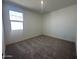 Bedroom featuring neutral carpet, a window, and white walls at 47219 W Pecan Woods --, Maricopa, AZ 85139